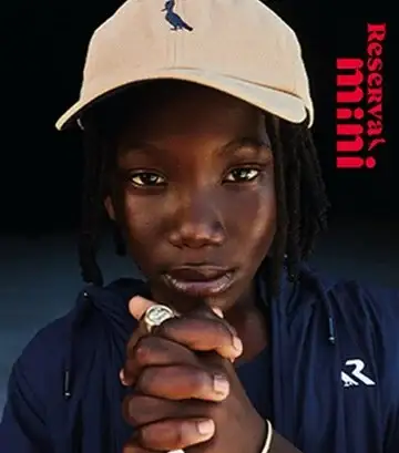 Menino modelo de boné em campanha de moda infantil